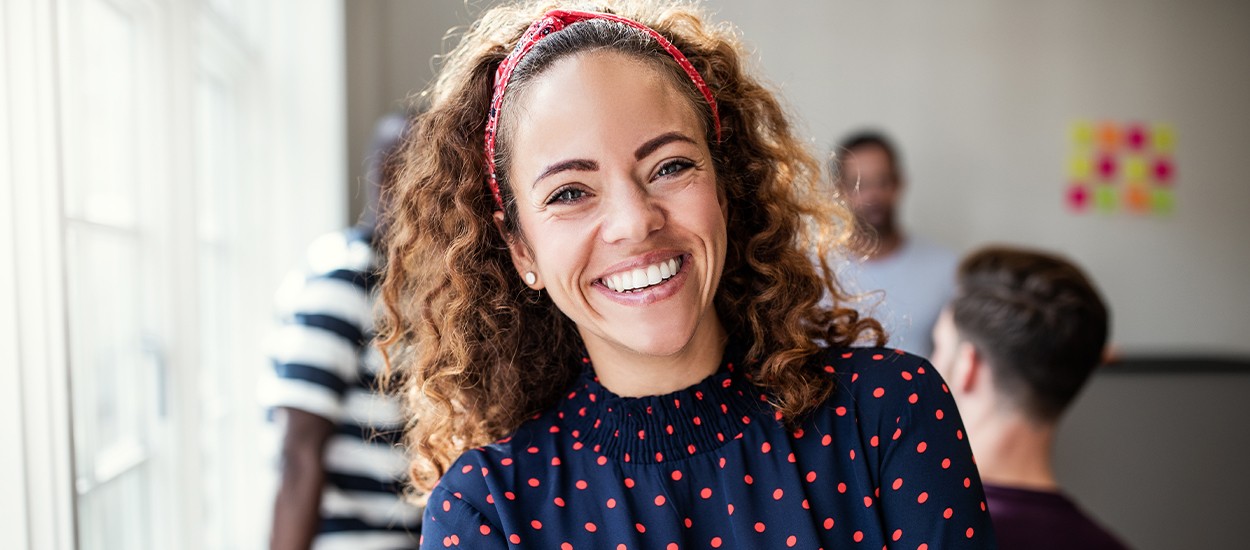 woman wearing polka dot shirt smiling