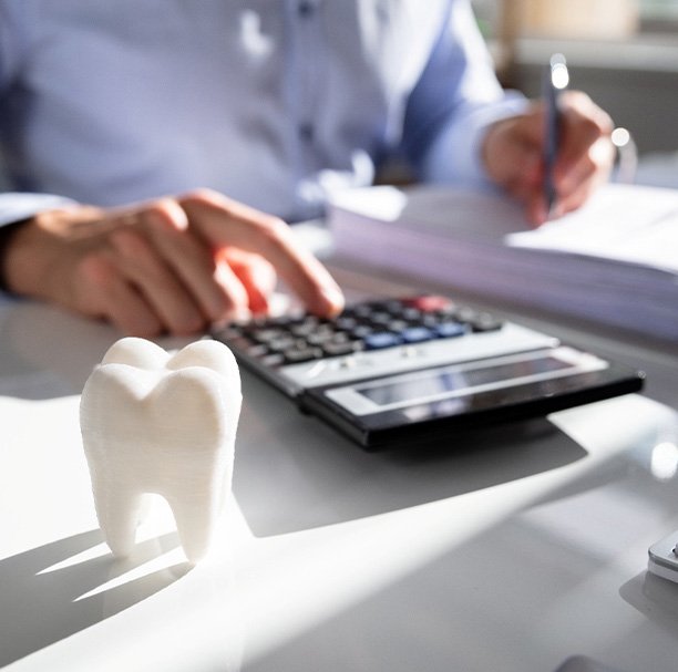 A patient trying to calculate the cost of their dental treatment