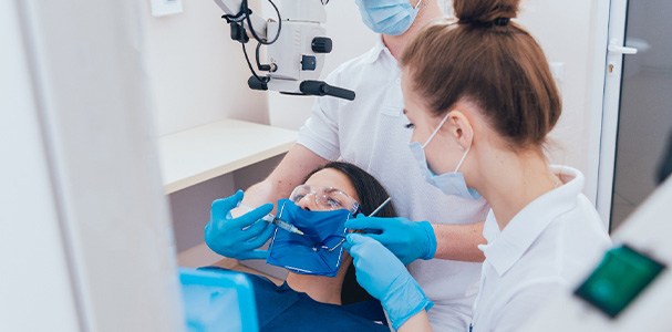 Dentists performing a root canal