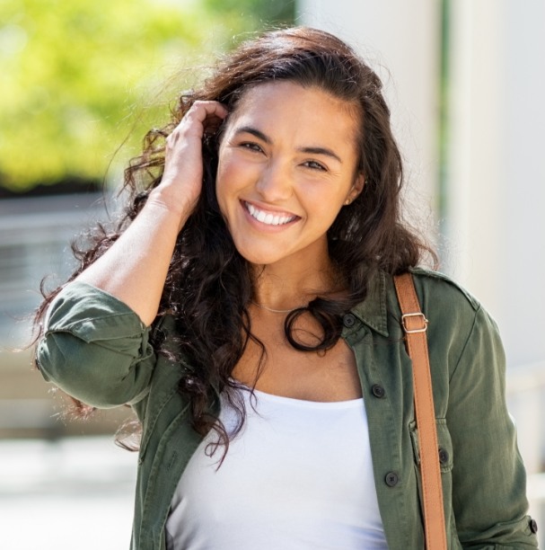 young woman smiling outside