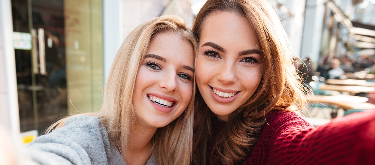 two women taking selfies