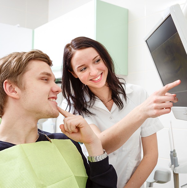 woman pointing to x-ray with man