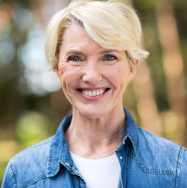 woman in jean jacket smiling