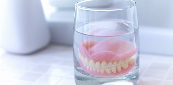 Dentures soaking in a solution