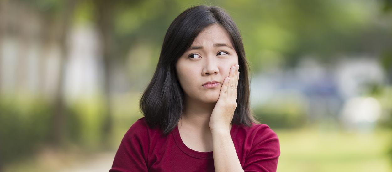 woman outside with dental pain