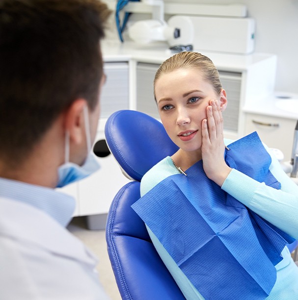 woman talking to dentist in pain