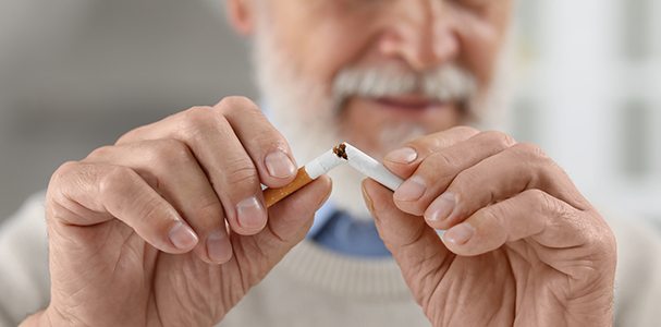 Man breaking cigarette