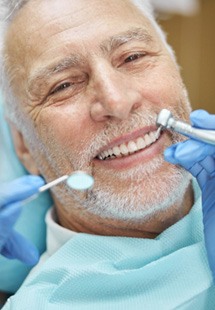 man smiling while visiting dentist