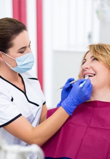 woman smiling while visiting dentist 