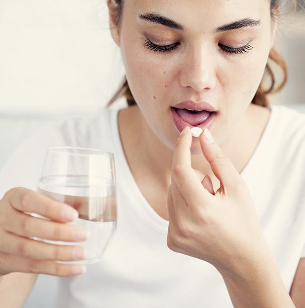 woman taking antibiotics