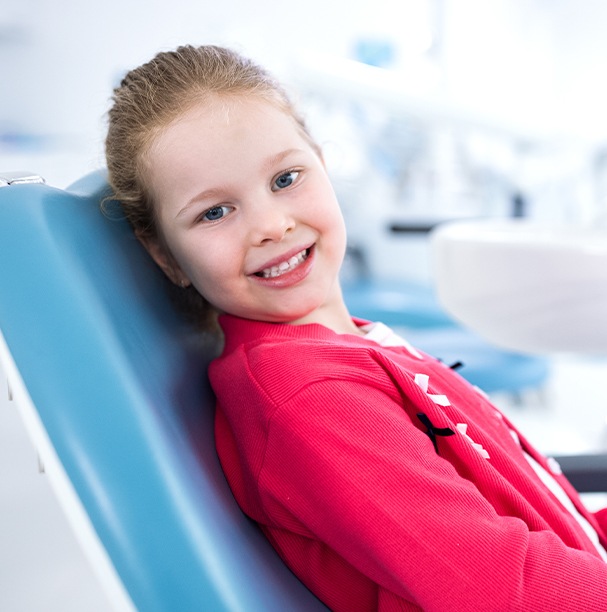 young girl smiling in exam chair