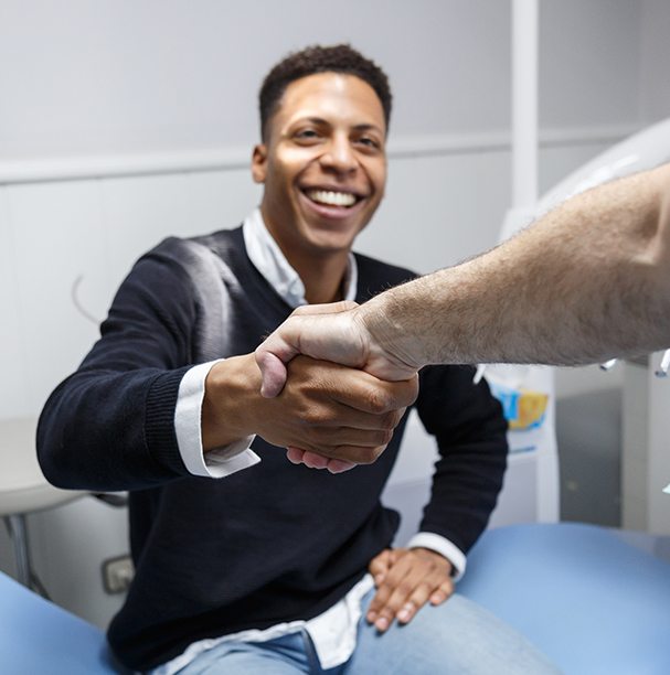 man shaking dentist hand