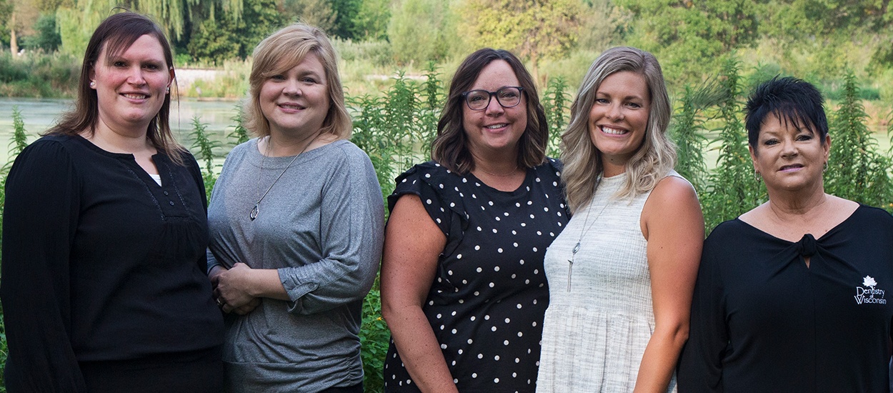 5 wisconsin team members smiling