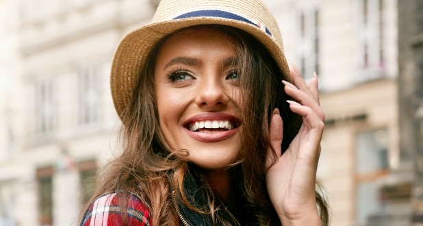 woman with hat on smiling