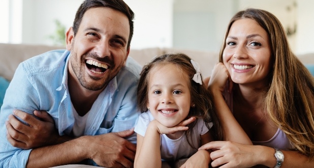 family of three smiling