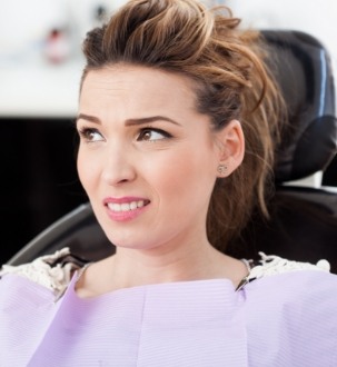 Girl in dental chair looking Nervous