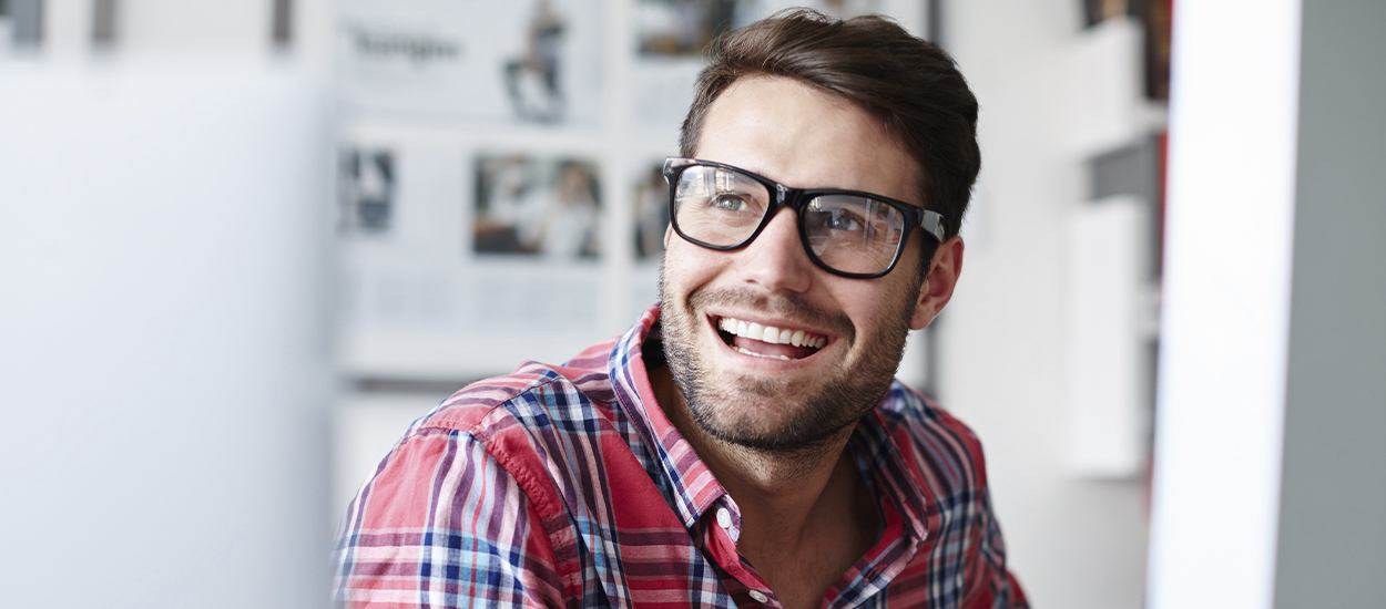 man with glasses smiling