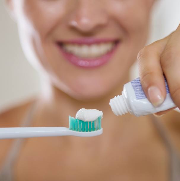 woman holding tooth brush and toothpaste