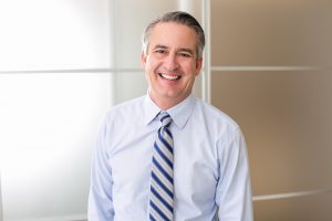 Businessman smiling with dental implants