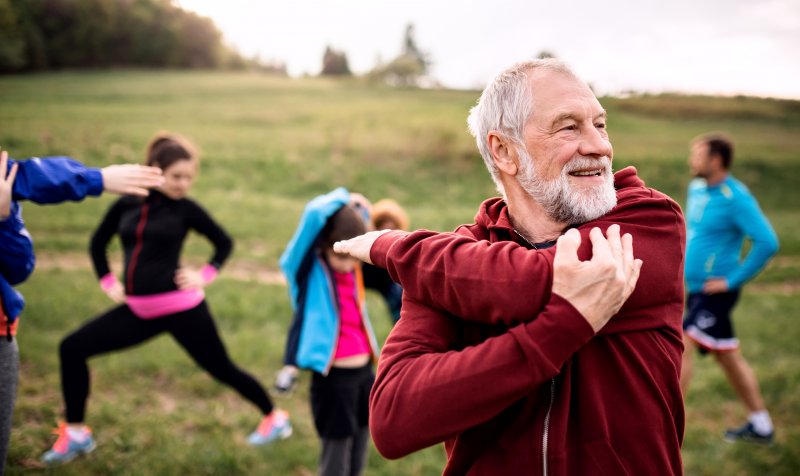 older man exercising with group of people