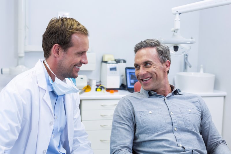 person talking to dentist about removing a failed dental implant 
