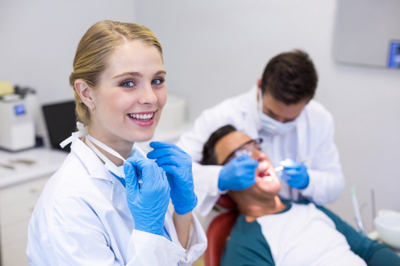 dental hygienist standing in an office and smiling