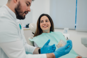 a young woman and a dentist chatting about dentures