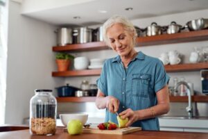 Woman with dental implants preparing a balanced meal