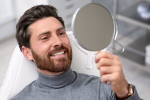 Man smiling after his cosmetic dental treatment